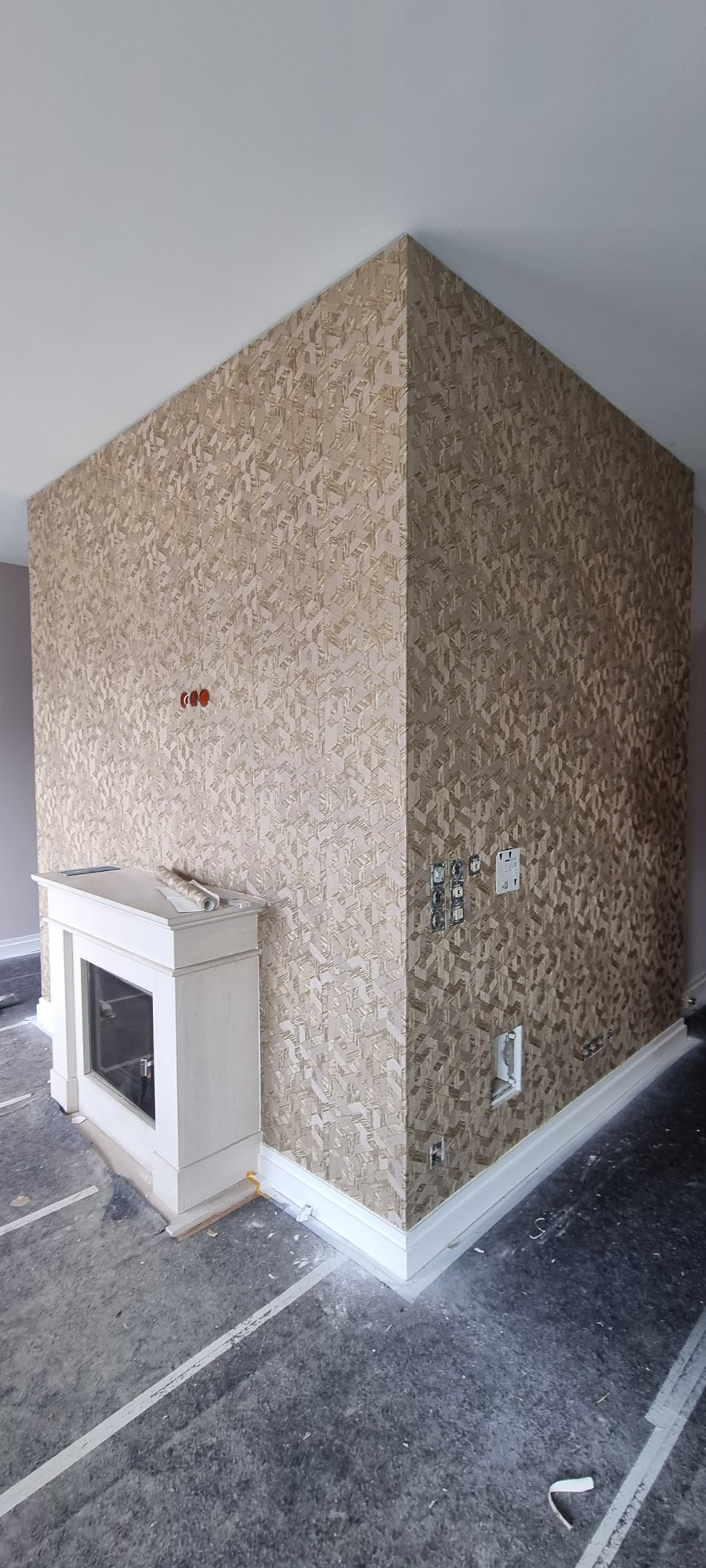 Wand mit Strukturtapete neben Kamin